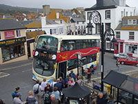 X53 bus at bus stop picking up passengers for Exeter” hspace=